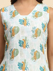 Sleeveless dress with cheetah and leaf print on light blue fabric, close-up view