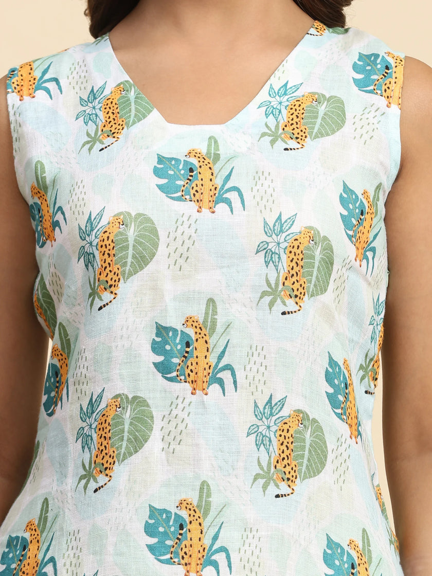 Sleeveless dress with cheetah and leaf print on light blue fabric, close-up view