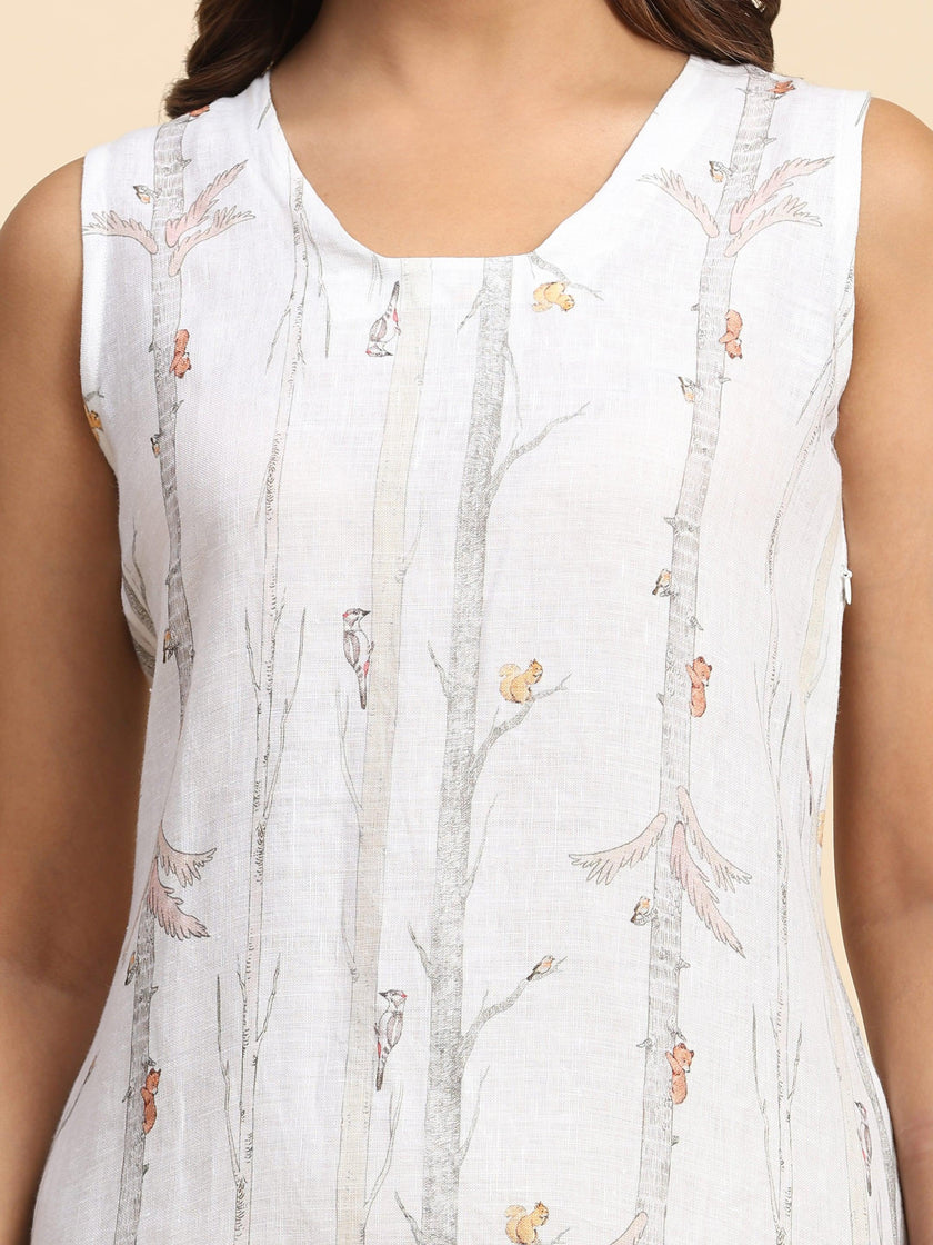 Sleeveless white linen top with nature print, featuring trees, squirrels, and birds