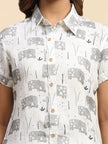 White collared shirt with gray elephant and floral print, short sleeves, wooden buttons
