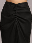 Close-up of black ruched high-waisted skirt in textured fabric