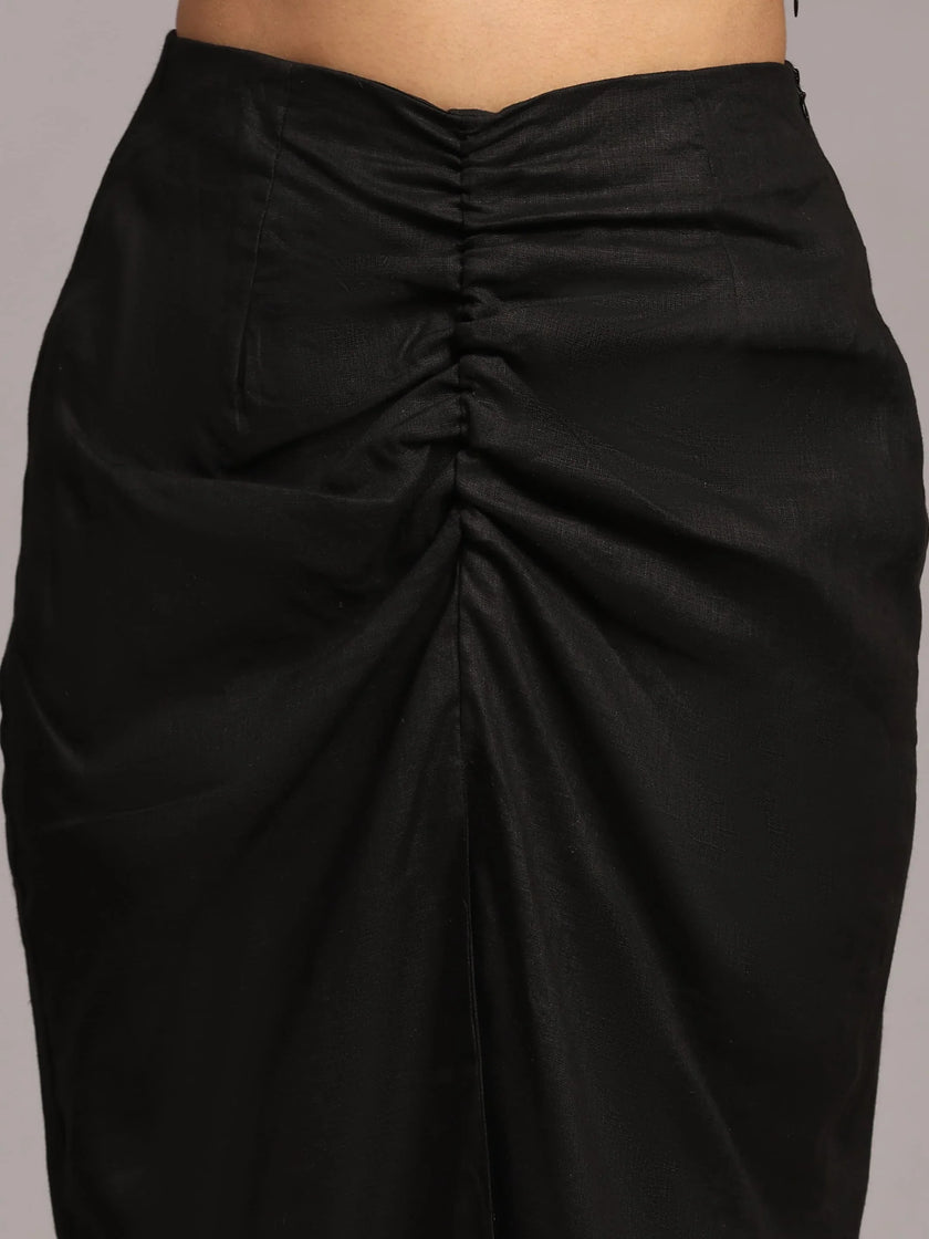 Close-up of black ruched high-waisted skirt in textured fabric