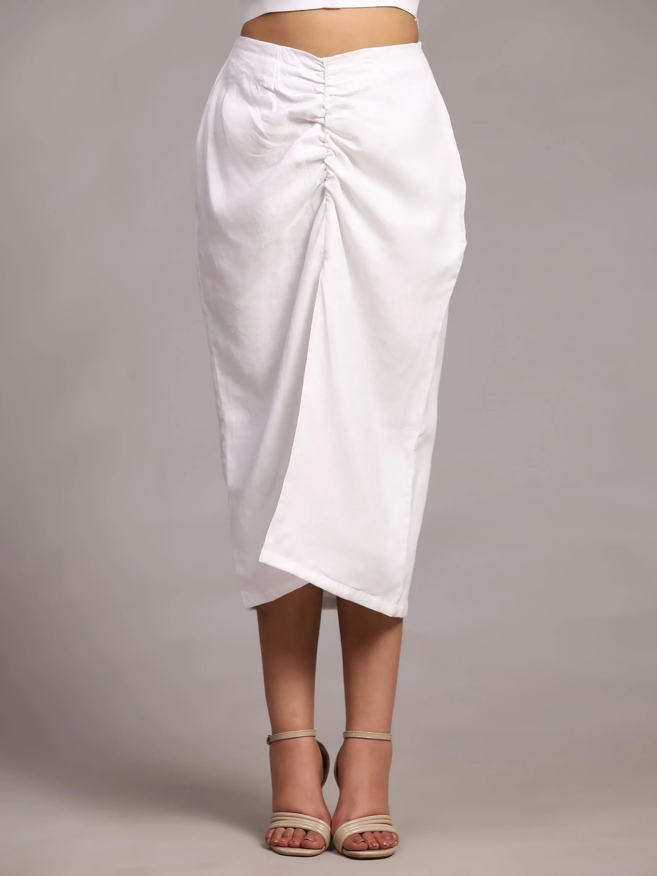 White ruched midi skirt with front drape detail, styled with nude strappy heels