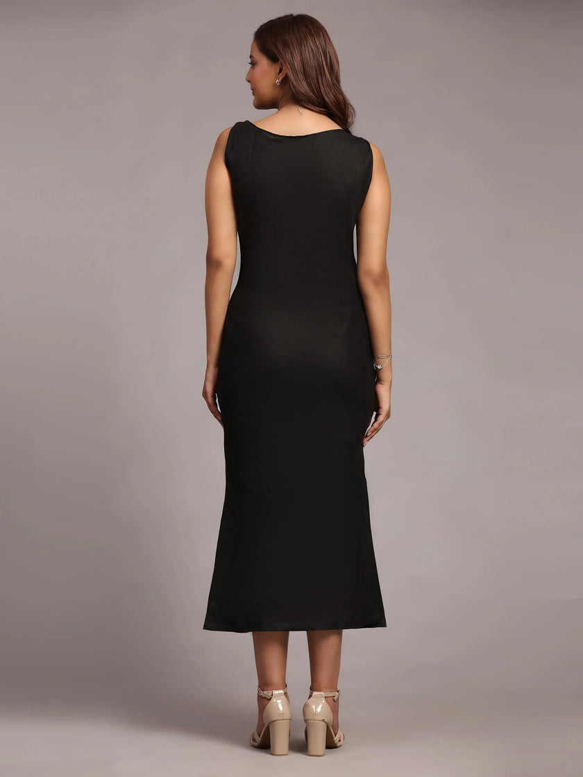 Woman in sleeveless black midi dress and beige heels, shown from the back, studio setting