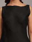 Woman wearing sleeveless black dress and delicate silver necklace