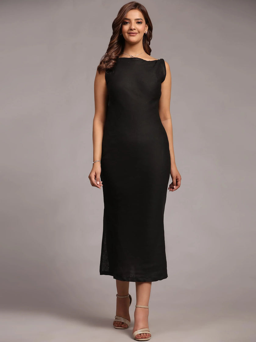 Woman in sleeveless black midi dress and heels posing against a neutral background