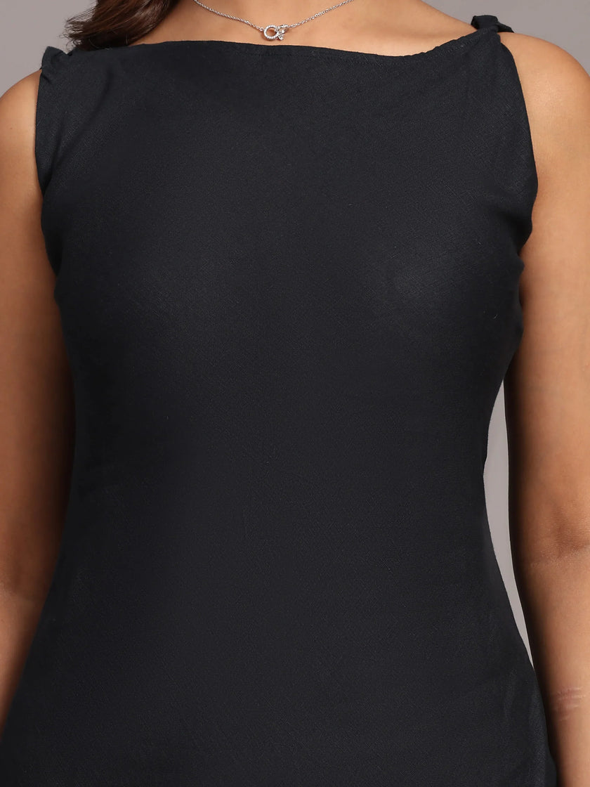 Sleeveless black dress with boat neckline, close-up on upper torso, elegant adult fashion