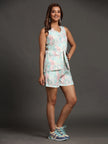 Woman wearing a pastel abstract print sleeveless top and shorts set with sneakers