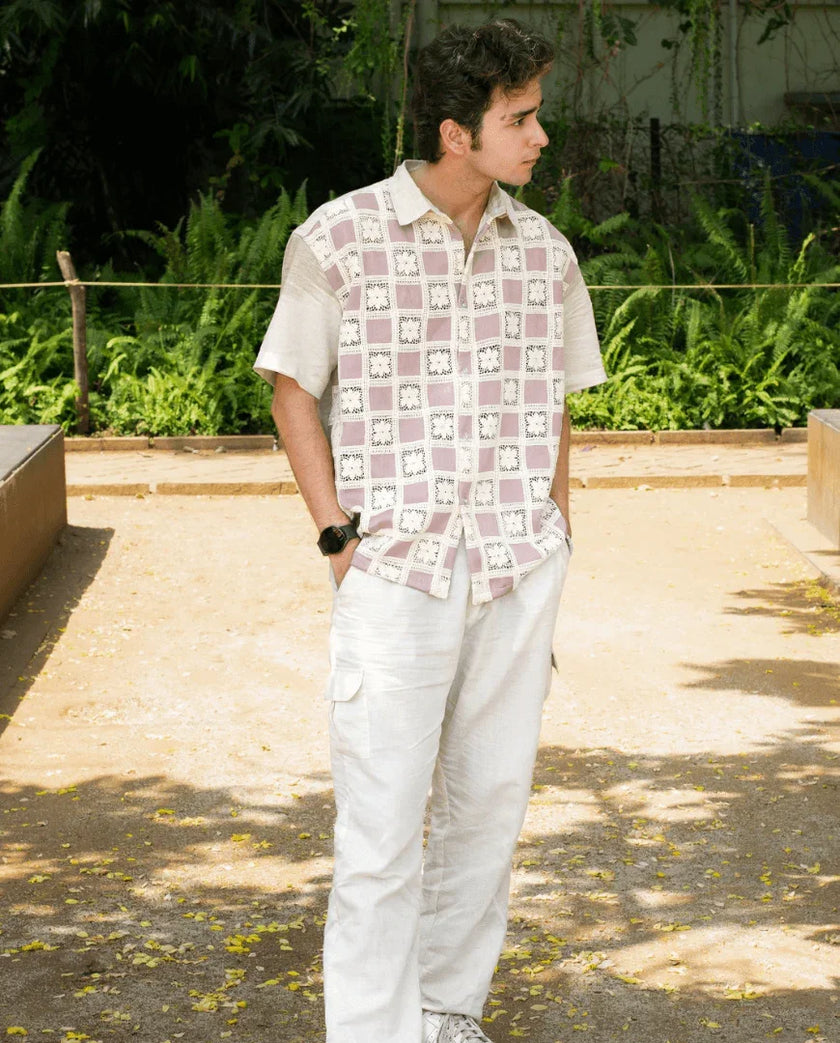 Man outdoors in short-sleeve patterned shirt and white cargo pants, casual fashion
